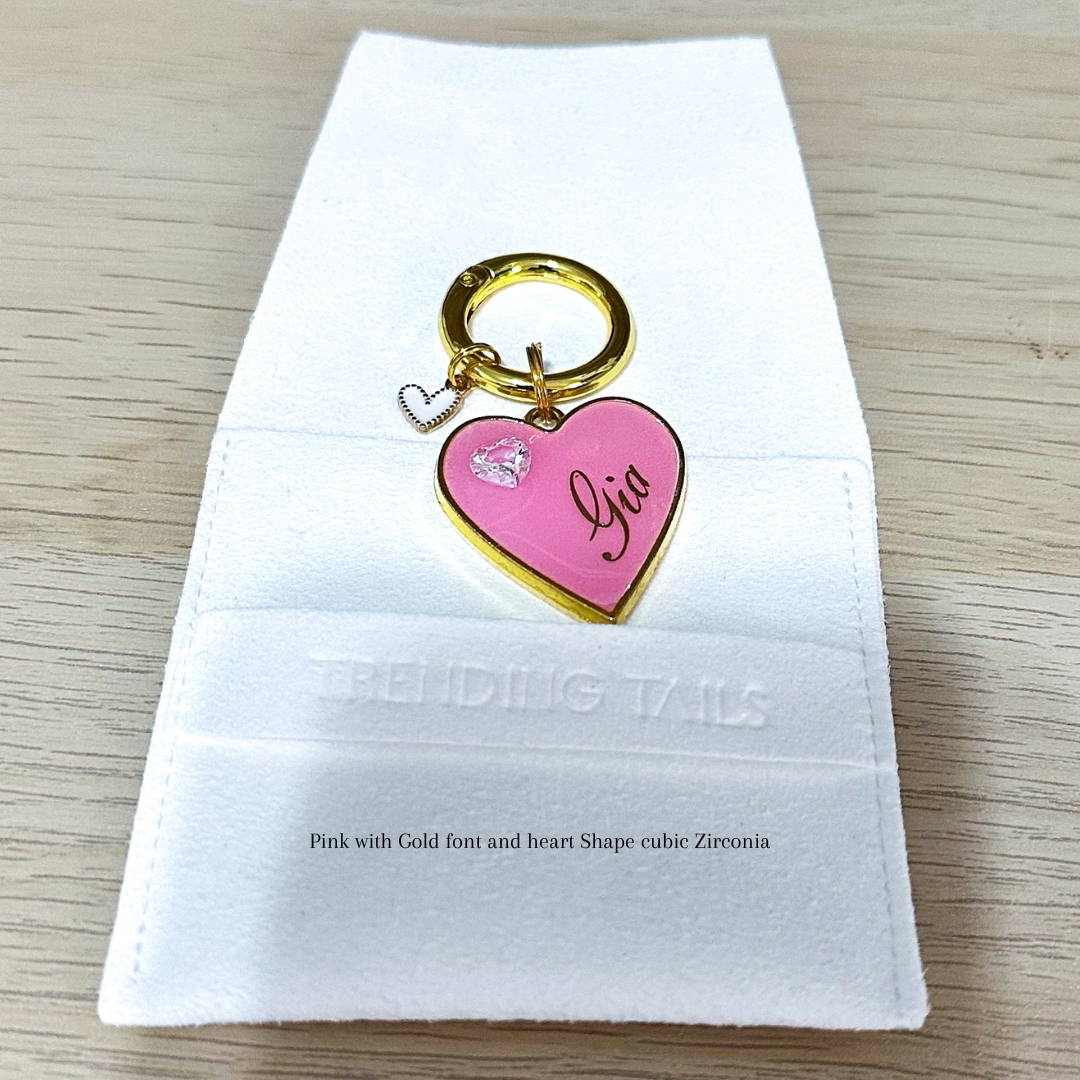 Pink heart-shaped pet ID tag with gold-plated stainless steel hardware and heart-shaped cubic zirconia crystal.