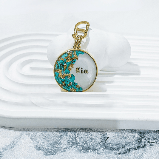 Round shimmery white pet ID tag with turquoise blue stones and gold flake, dog ID tag, cat ID tag, cute pet ID tag, trendy pet ID tag, stylish pet ID tag, durable pet ID tag, personalised pet ID tag, luxury pet ID tag, glamorous pet ID tag, custom pet ID tag, handmade pet ID tag, gold-plated stainless steel pet ID tag, resin pet ID tag, blingy pet ID tag, premium pet ID tag, high-end pet ID tag, designer pet ID tag, white and gold pet ID tag, gold foil pet ID tag, sparkly pet ID tag.