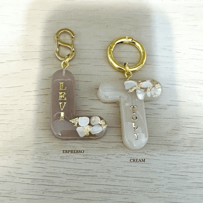 Espresso brown letter L and cream letter T personalised initial custom pet ID tag with gold-plated stainless steel hardware, seashells and gold flake.