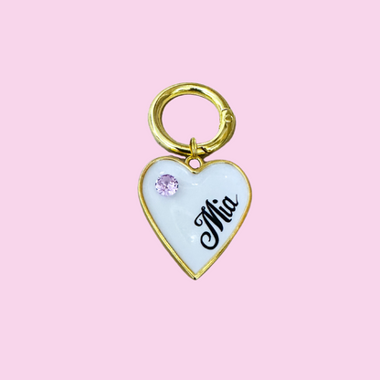 White heart-shaped pet ID tag with gold-plated stainless steel hardware and purple cubic zirconia crystal.