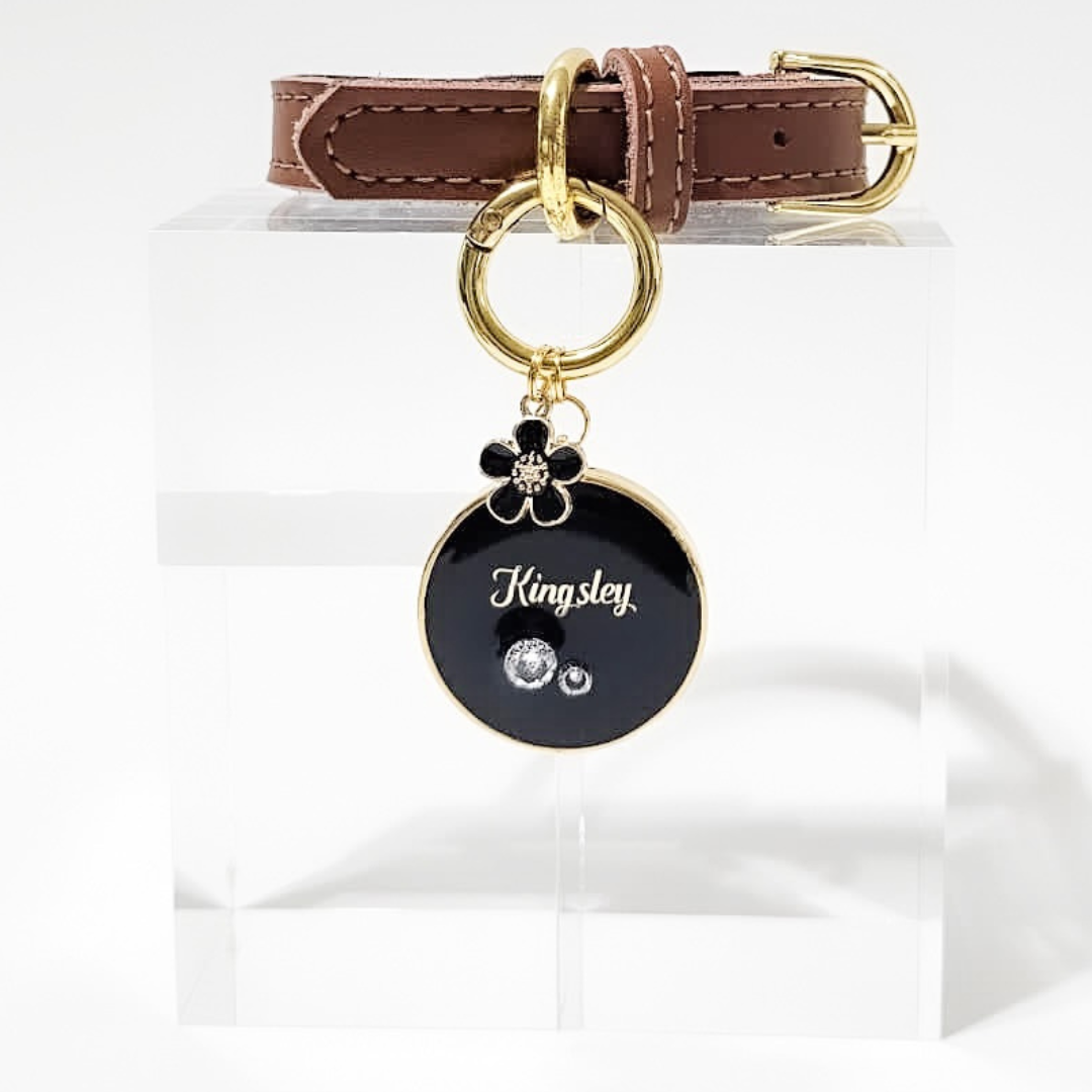 Round black pet ID tag with gold-plated stainless steel hardware and cubic zirconia crystals.