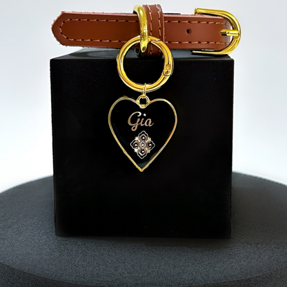 Black heart-shaped pet ID tag with gold-plated stainless steel hardware and Swarovski crystal on gold foil pattern.