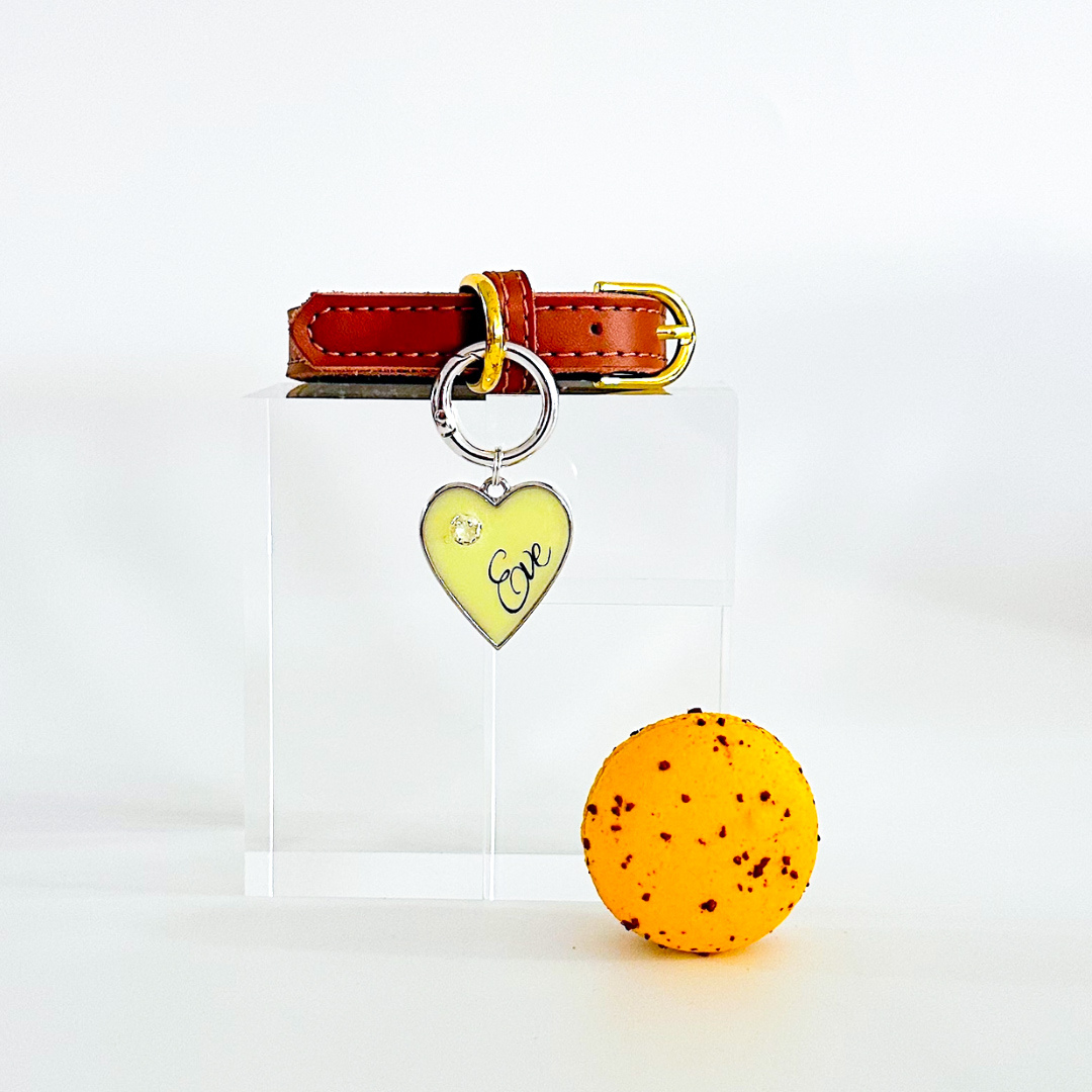 Pastel yellow heart-shaped pet ID tag with silver stainless steel hardware and cubic zirconia crystal.