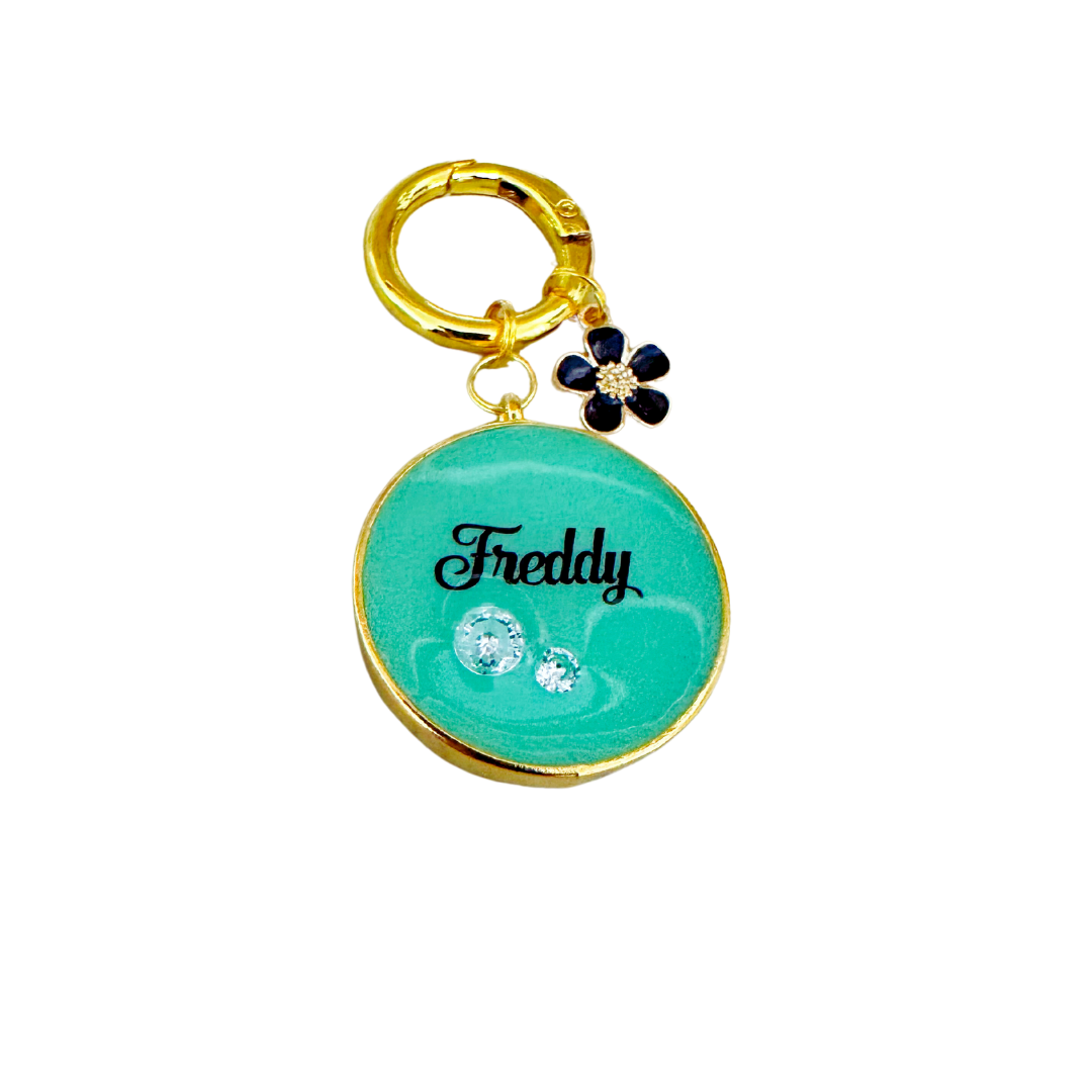 Shimmery aqua blue round pet ID tag with gold-plated stainless steel hardware and cubic zirconia crystals.