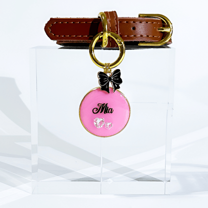 Pink round pet ID tag with gold-plated stainless steel hardware and heart-shaped cubic zirconia crystals.