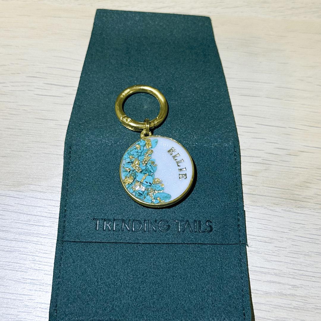 Shimmery white round pet ID tag with gold-plated stainless steel hardware, turquoise blue stones and gold flake.