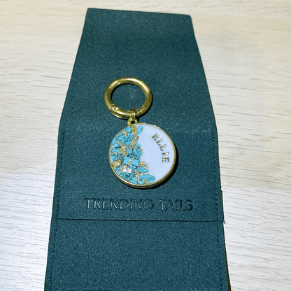 Shimmery white round pet ID tag with gold-plated stainless steel hardware, turquoise blue stones and gold flake.