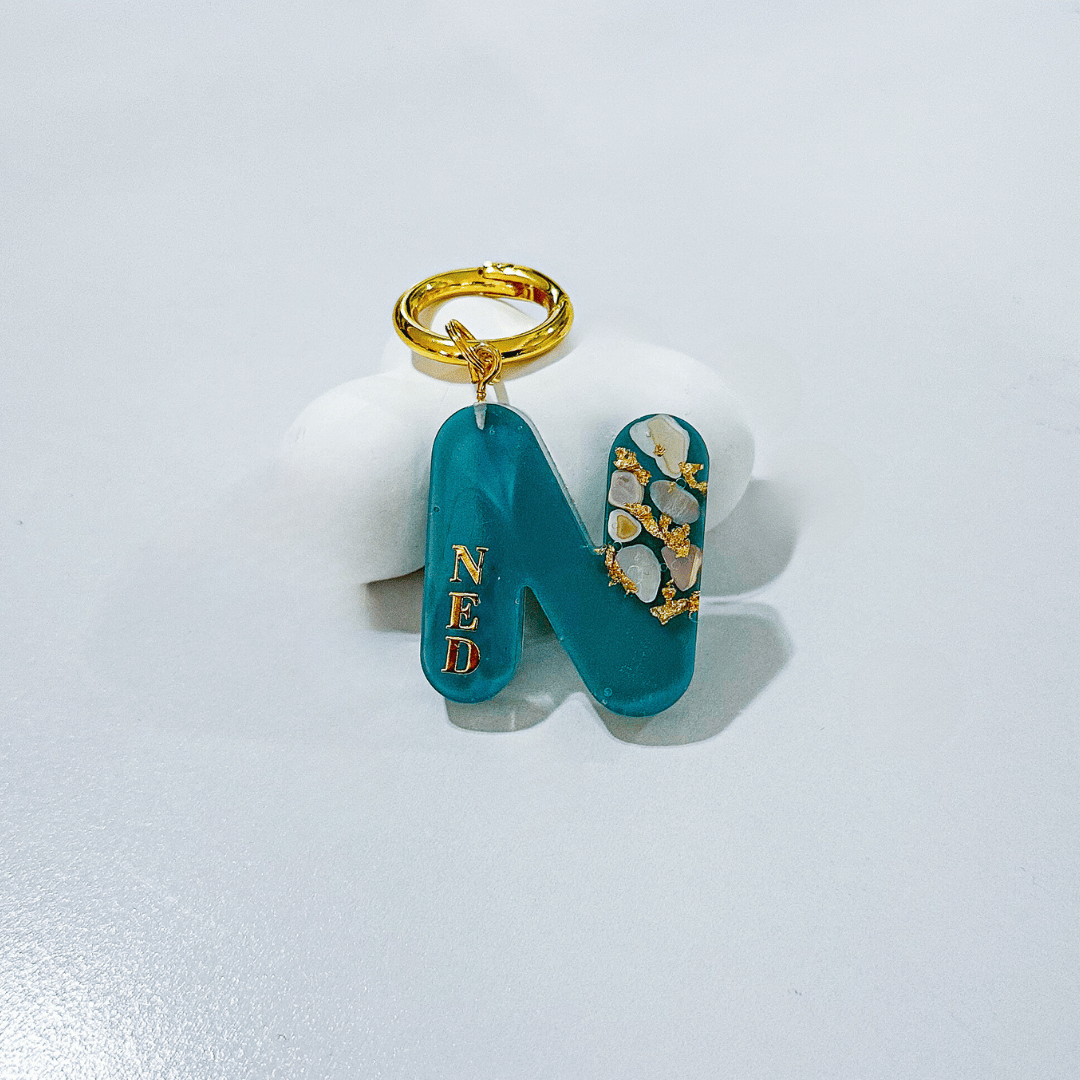 Blue letter N personalised initial custom pet ID tag with gold-plated stainless steel hardware, seashells and gold flake.