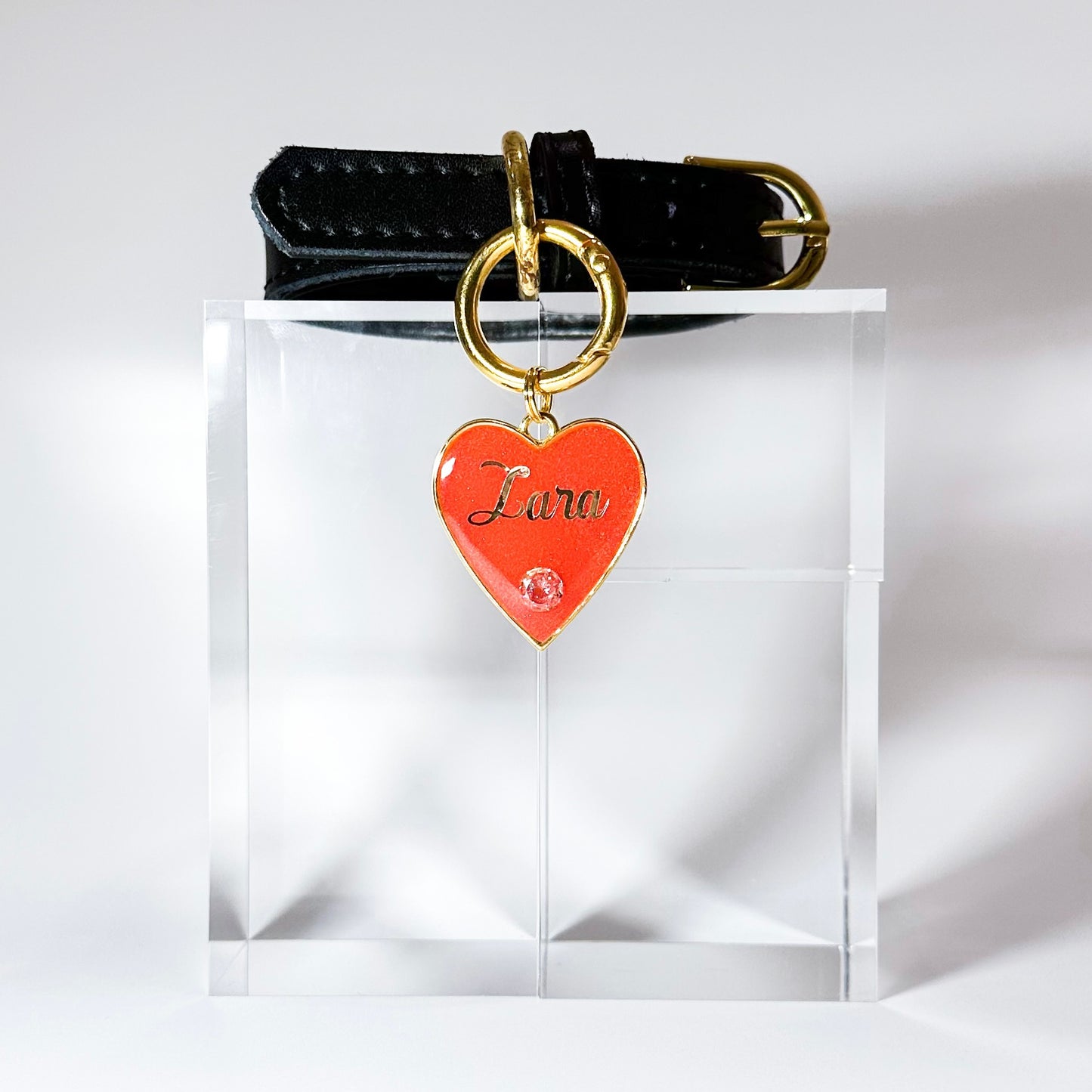 Shimmery watermelon red heart-shaped pet ID tag with gold-plated stainless steel hardware and cubic zirconia crystal, sparkly red and and gold pet ID tag.