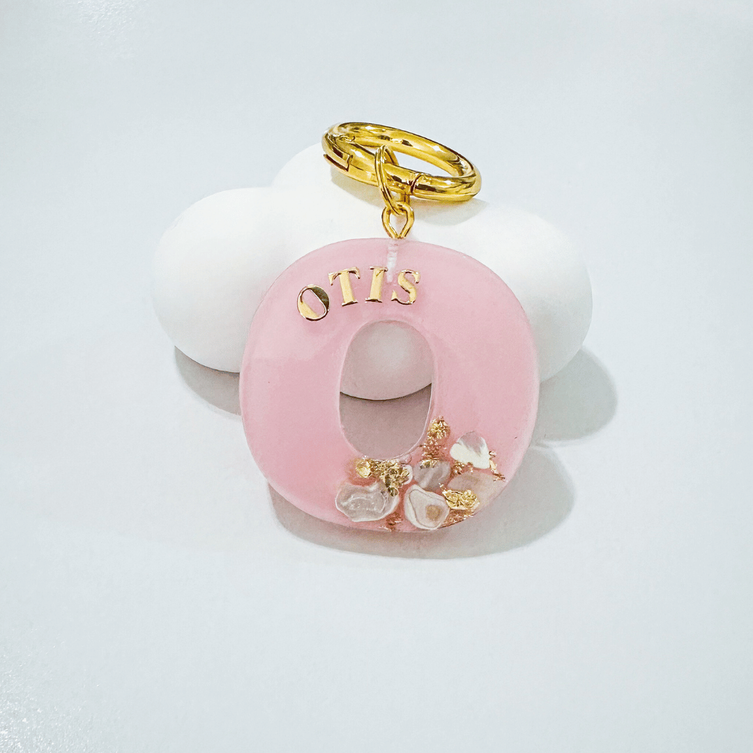 Pink letter O personalised initial custom pet ID tag with gold-plated stainless steel hardware, seashells and gold flake.