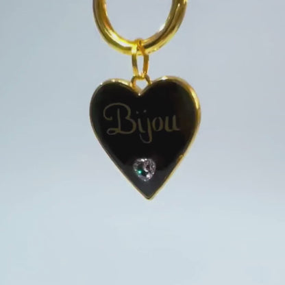 Black heart-shaped pet ID tag with gold-plated stainless steel hardware and heart-shaped cubic zirconia crystal.