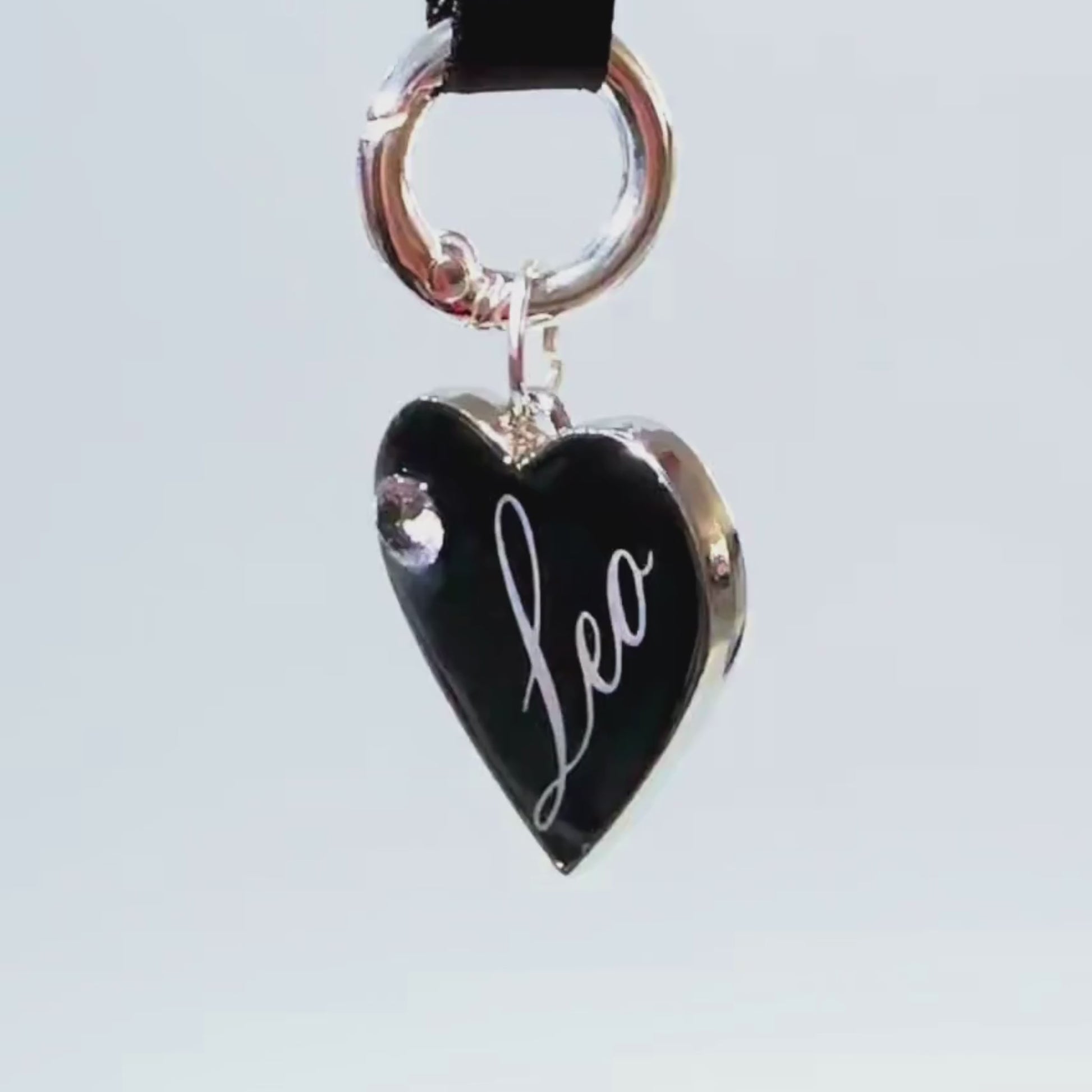 Black heart-shaped pet ID tag with silver stainless steel hardware and cubic zirconia crystal.