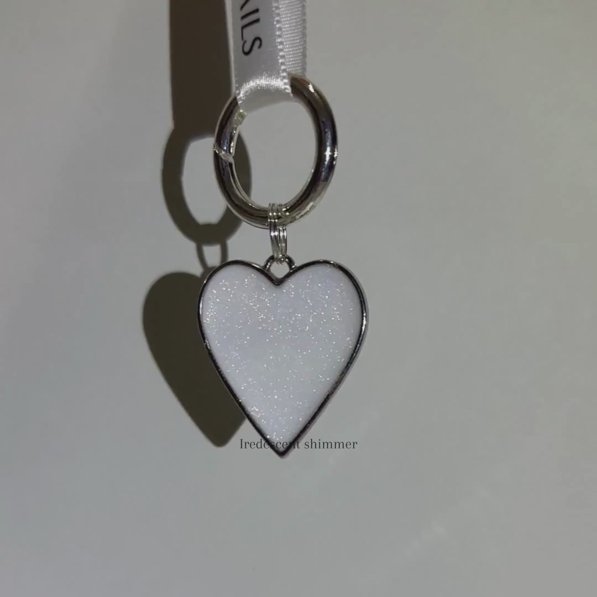 Iridescent shimmer white heart-shaped pet ID tag with silver stainless steel hardware.