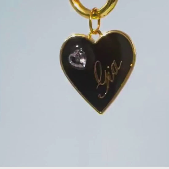 Black heart-shaped pet ID tag with gold-plated stainless steel hardware and heart-shaped cubic zirconia crystal.