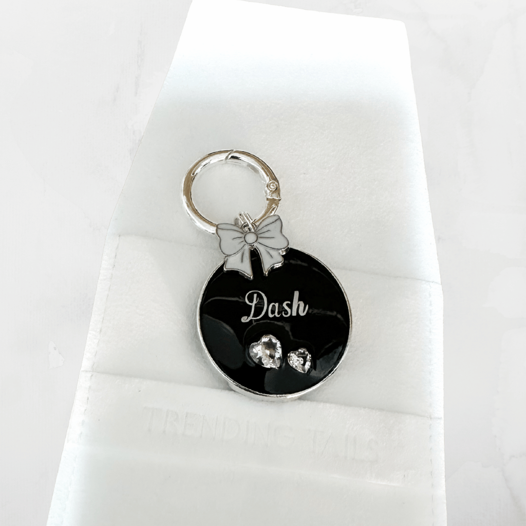 Round black pet ID tag with silver stainless steel hardware and heart-shaped cubic zirconia crystals, black and silver pet ID tag.