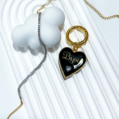 Black heart-shaped pet ID tag with gold-plated stainless steel hardware and heart-shaped cubic zirconia crystal.